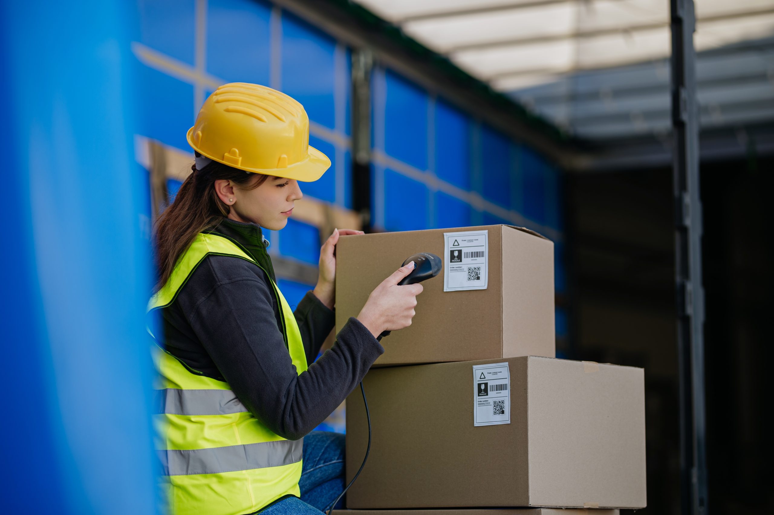 Warehouse,Receiver,Kneeling,Inside,Of,Truck,In,Cargo,Area,,Trailer,